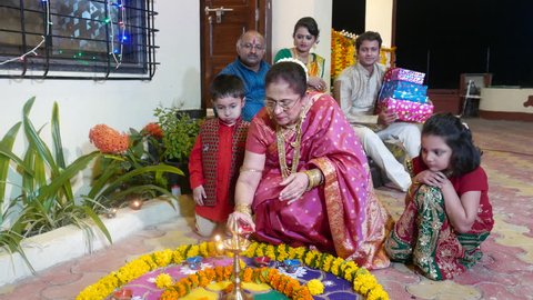 4K video footage of Indian family in traditional outfits celebrating Diwali or deepavali, festival of lights at home.  Video Stok