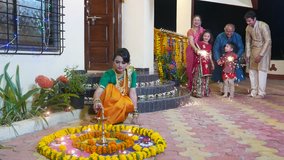 4K video footage of Indian family in traditional outfits celebrating Diwali or deepavali, festival of lights at home. 