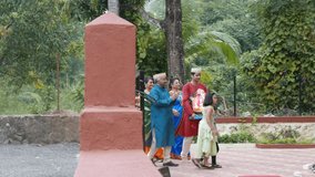 4K video footage of Indian family in traditional outfits celebrating Ganesha festival by bringing the Ganesha idol at home. 