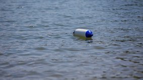EVENT LUKOVICA JUNE 2015:In this short video, we can see a buoy lying on the surface of the lake. Close-up shot.