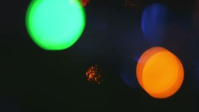 Blinking holiday colorful bokeh light circles blur background.