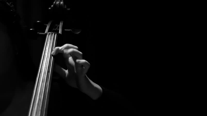 A girl playing on cello in an empty theater hall. Black and white style. | Shutterstock HD Video #12587369