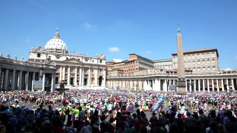 Crowd of tourists gathered on square near Saint Peters Cathedral, Rome, Italy. T