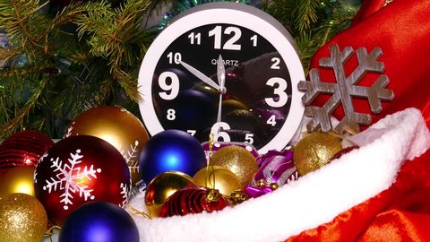 Clock and christmas balls and toys in a red bag, timelapse, 4k