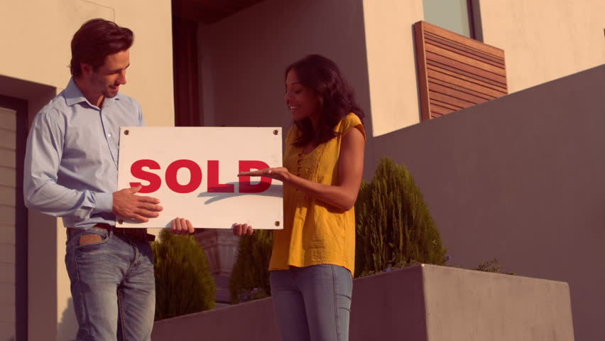Portrait of smiling Hispanic couple front of their new house at home Royalty-Free Stock Footage #12597587