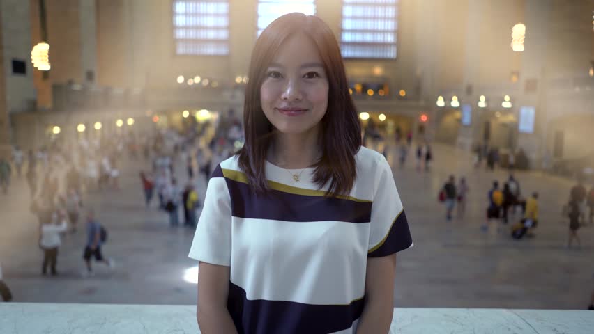 young women looking at camera smiling. female posing for picture. city people lifestyle background