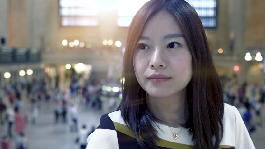 cute asian women looking at camera smiling. female posing for picture. city people lifestyle background