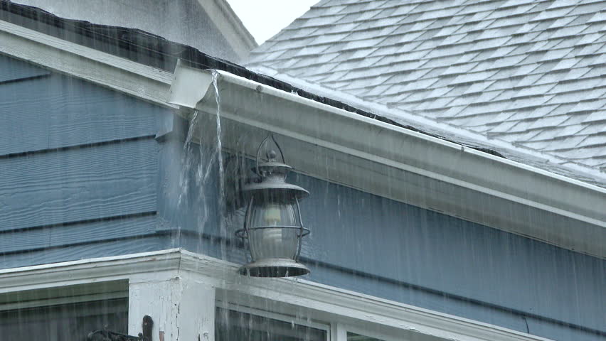 Heavy rain falling on house fills up house gutters in Portland, Oregon. Royalty-Free Stock Footage #12602549