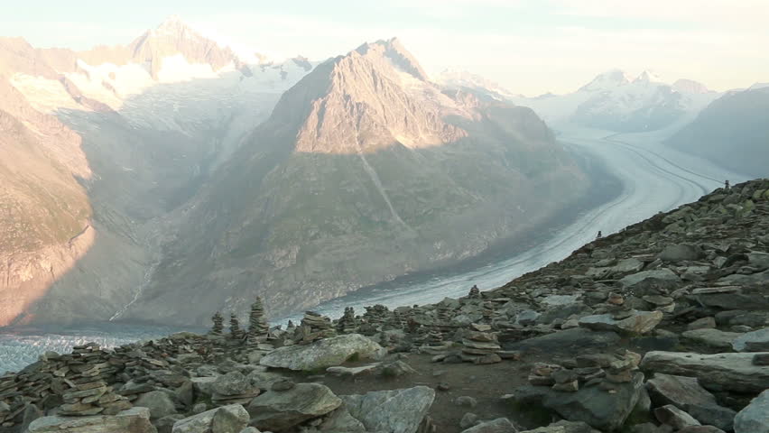 Man walking in swiss mountain. Aletsch glacier in background.
Wide view (closer views available).
1080p25 - 25 sec.