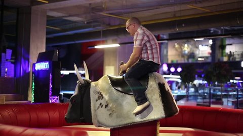 A man riding a bull