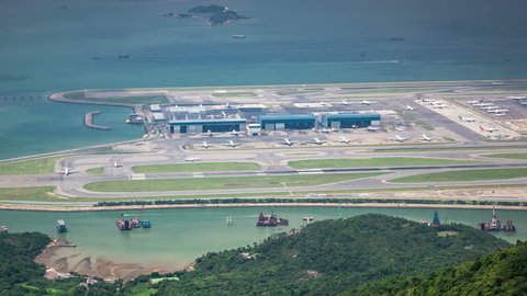 International airport - taxiways, runways, airport terminals, aircrafts, airplanes, planes and lounges, takeoff and landing in Hong Kong. Timelapse. 