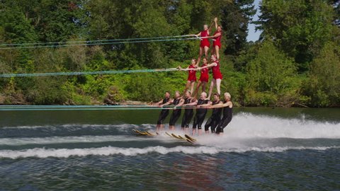 Cinemagraph - Stunt water skiers form human pyramid . Motion Photo.