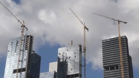 A time-lapse movie of a construction project in a big city while the clouds moving behind.