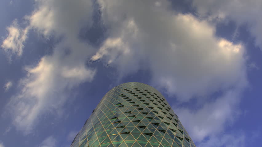 Westhafen Tower reflects the sky and turns around