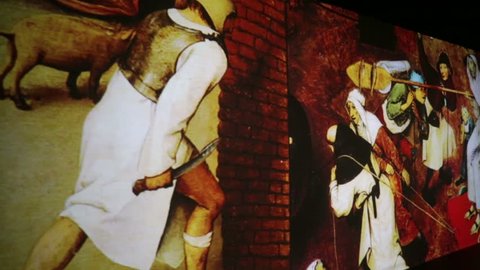 MOSCOW, RUSSIA - OCTOBER 21, 2015: People watch multimedia exhibition "Renaissance - Live canvases". Leonardo da Vinci, Titian, Raphael, Caravaggio, Botticelli, etc.- paintings of Renaissance artists.