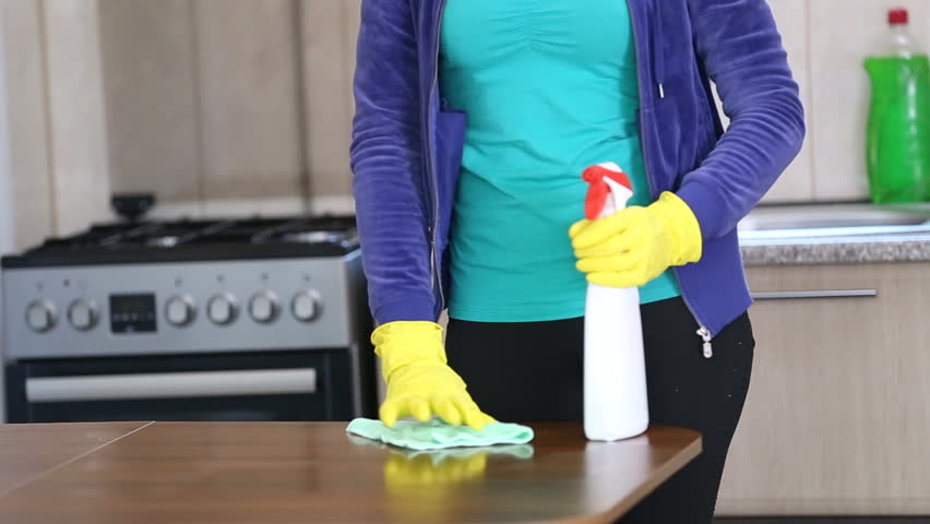 young girl cleans the kitchen