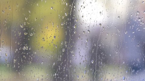 Rain drops on a car window glass, handheld shallow focus