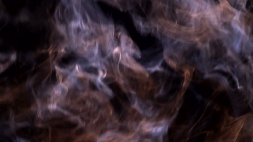 Smoke rising up against black background