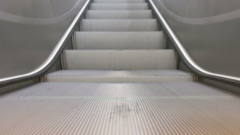 Medium zoomed  detailed close up of running escalator stairs in the airport