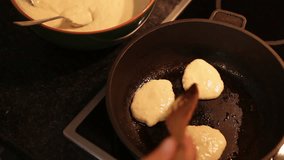 Oladji (little pancakes) roasting on the pan top view