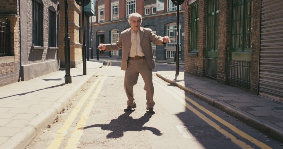 Happy elderly dancer man wearing suit funky street dancing freestyle in the city | Shutterstock HD Video #12658772