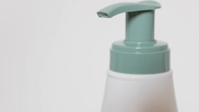 Plastic pump liquid dispenser for hands and body oils close-up 4K 2160p 30fps UHD footage - Close-up body milk bottle with sprayer 4K 3840X2160 UltraHD tilt video