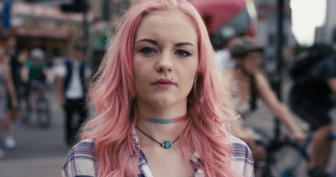Slow Motion Portrait of caucasian girl with pink hair in city real people series