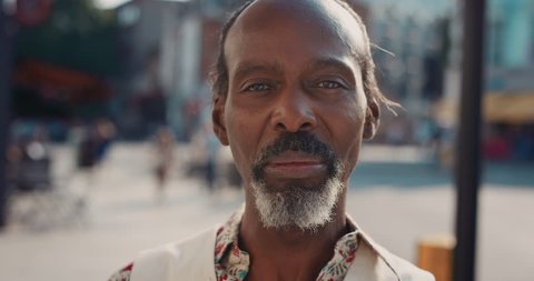 Slow Motion Portrait of happy mature african american man smiling in city real people series
