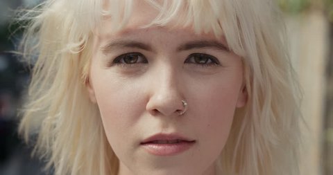 Close up Slow Motion Portrait of beautiful caucasian woman wearing nose ring in the city real people series