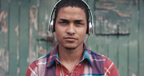 Slow Motion Portrait of mixed race man listening to music in the city urban face normal people series