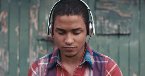 Slow Motion Portrait of mixed race man listening to music in the city urban face normal people series
