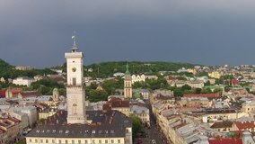 Aerial video. Lviv Town Hall. Lviv Town Hall stands In the center of the market square. It was built in the 19th century. The tower is 65-meter (213 feet) tall.  Its unique architectural ensemble