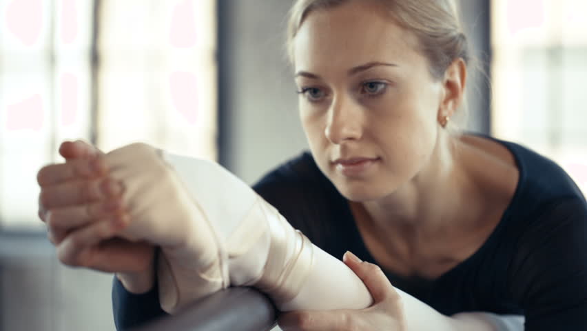 Female Ballet Dancer stretches and practices,dolly shot