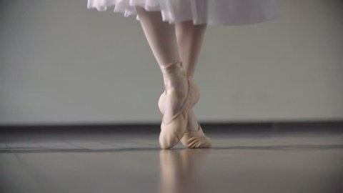 Close up of a ballet dancer's feet as she practices point exercises,slow motion