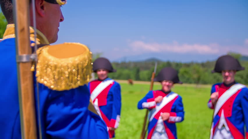 Napoleon army is saluting with their riffles on battleground in a beautiful nature on countryside.