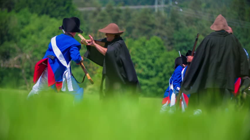 This two army is fighting during the battle on battleground in a beautiful nature on countryside.
