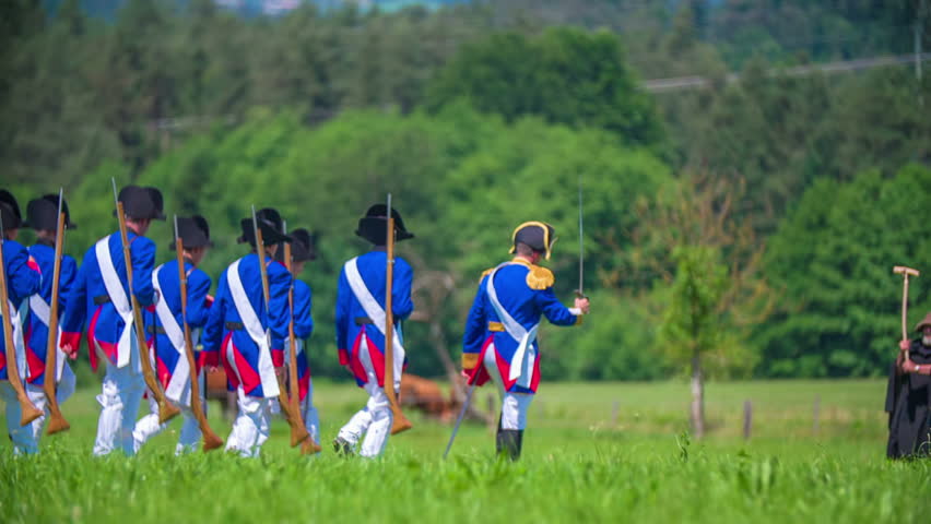 The historical army is attacking the opposite army on battleground in a beautiful nature on countryside.
