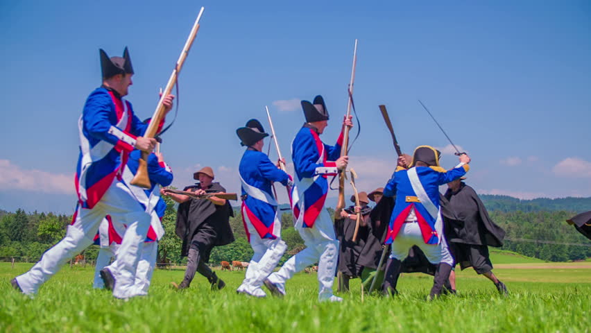 Napoleon army is fighting on the reconstructed battle on battleground in a beautiful nature on countryside.