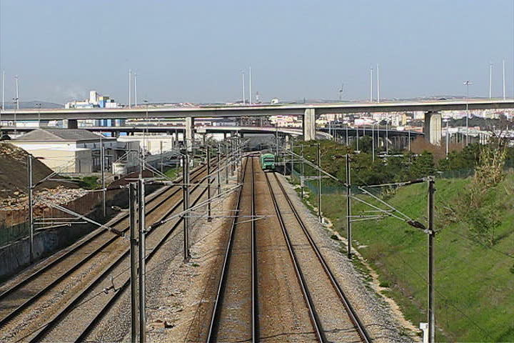 Passenger train passing under bridge 