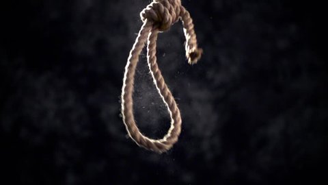 Rope noose with hangman knot in front of dark background.