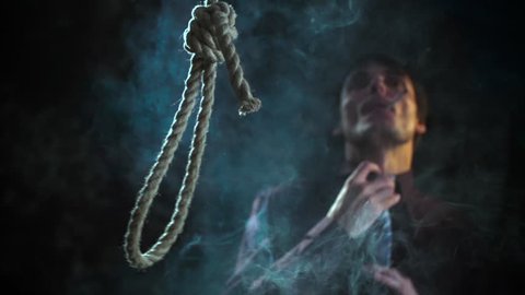 Social commercial. Smoking kills. Man smoking cigarette. Noose loop rope for suicide falling. Slow Motion 400 fps Conceptual