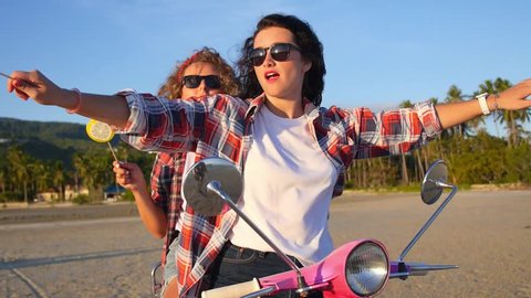 Young Hipster Women on Scooter at Beach. Slow Motion. HD, 1920x1080.