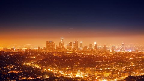 Cinemagraph - Air traffic over city of Los Angeles cityscape, downtown skyline at night. 4K UHD Motion Photo.