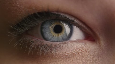 Close-up shot of a woman opening her blue eyes with light day make-up and focusing them. Shot on RED Cinema Camera in 4K (UHD).