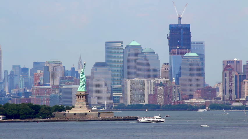 The Statue of Liberty near Ellis Island with New York City in the background. 