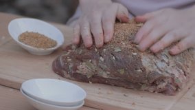 EDIT MULTICAM VIDEO Woman  Sprinkling and rubbing all sides of fat pork by the remaining mixed kitchen spicy herbs. 