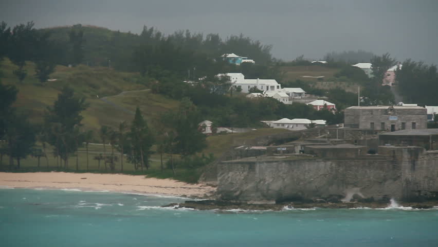 Sailing past Fort St. Catherine on the island of Bermuda on a cloudy day.
