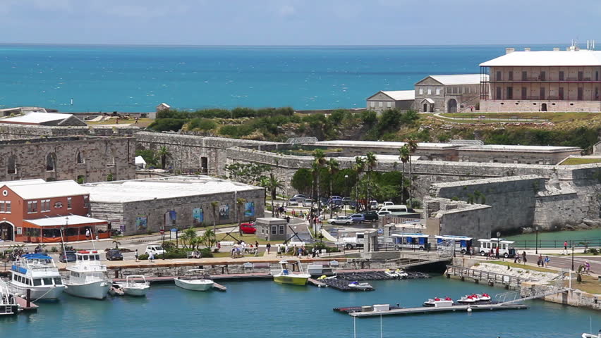 Tourists visit the shops and attractions at King's Wharf on the island of