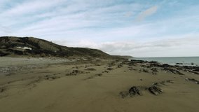 Aerial Footage panning from the beach towards the sea