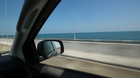 Driving. Florida Keys. Driving on a causeway in the Florida Keys. Highway barrier and blue ocean. 